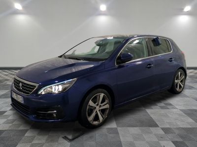 a blue car is parked in a room with a checkered floor