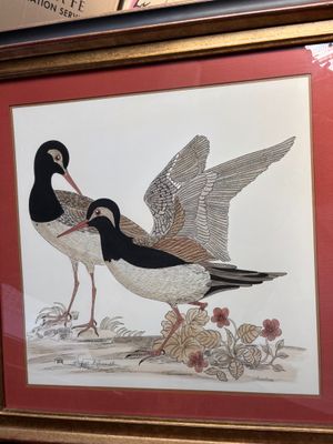 une photo représentant deux oiseaux posant dans un cadre