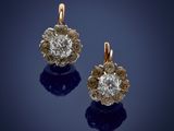 a pair of diamond and gold earrings
