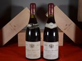 two bottles of wine sitting next to each other on a table