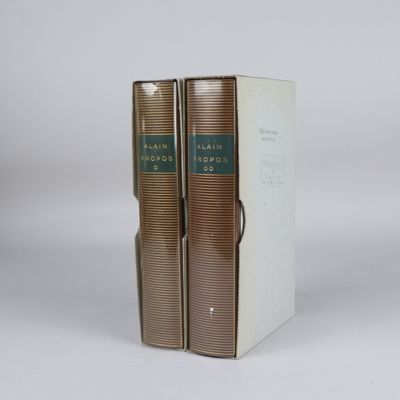 two books sitting on top of each other on a white surface