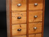 an old wooden chest of drawers with many drawers on top