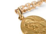 an image of a close up of a gold medal on a chain