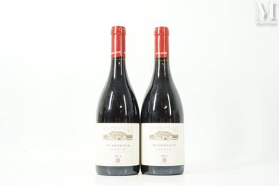deux bouteilles de vin rouge posées l'une à côté de l'autre sur une surface blanche