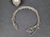 a close up of a silver ball and chain on a table