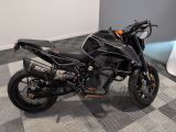 a black motorcycle parked in a room with a checkered floor