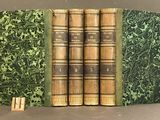 a set of four books sitting on top of each other on a table