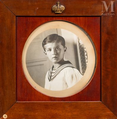 portrait of a young boy in a sailor ' s uniform in a wooden frame