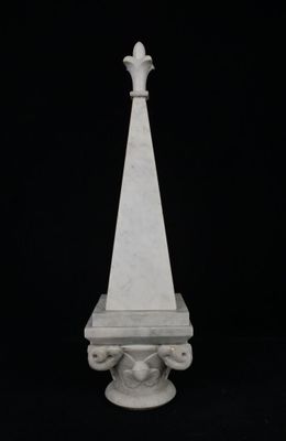 marble obelisk in the shape of a cross on a black background