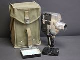 a camera and a bag sitting on a table