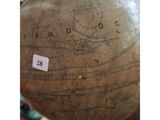 a large globe on a table with a sticker on it