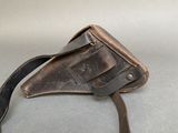 a brown leather bag with a brown strap on it