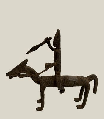 statue of a man riding a horse with a spear on its back