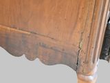 a close up of a bed with a wooden headboard