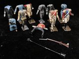 a group of toy soldiers that are on a black surface
