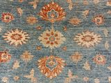 a close up of a person ' s feet on a blue rug