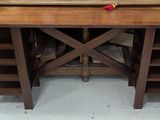 a wooden table with a red apple on it