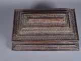 an old wooden box sitting on top of a gray surface