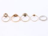 three gold and silver rings, one with a diamond and the other with a diamond