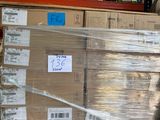a cat that is sitting on a pallet in a warehouse