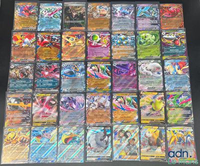 the collection of pokemon cards are displayed on a table