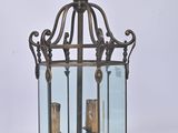 an old fashioned lantern with two candles inside of it on a white background