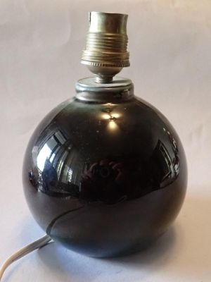a black lamp that is sitting on a white table