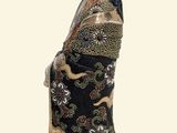 a statue of a woman wearing a black and gold kimono