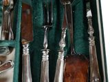 a green case with silverware in it on a table