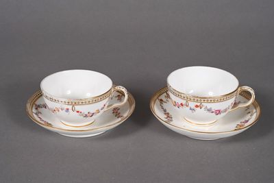 pair of porcelain cups and saucers with gold trims