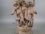 statue of a group of cherensils holding a globe on a pedestal