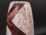 a close up of a vase with a bird on it