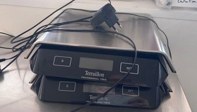 two electronic devices sitting on top of a metal table