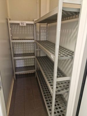 a small room with shelves and shelves in it