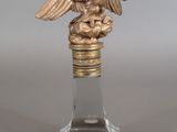 a glass bottle with a gold eagle on it