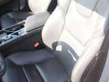 the interior of a car with two leather seats and a steering wheel