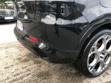 a black car that is parked on the side of the road