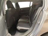 the back seats of a silver car with a black seat belt