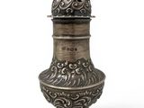 a silver vase with a lid and a decorative design on it