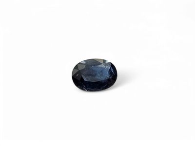 a close up of a blue sapphire stone on a white surface
