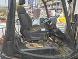 a forklift with a dog sitting in the back of it
