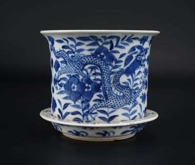 a blue and white cup with a saucer on a saucer