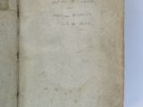 an open book with writing on it sitting on top of a table
