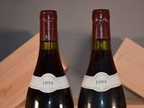 pair of bottles of wine sitting on top of a wooden crate