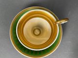 a cup and saucer sitting on a table