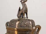 a metal container with a dog on top of it