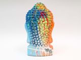 a colorful sculpture of a buddha head on a white surface