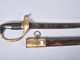 an old sword with a brass handle and a wooden handle