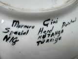 a close up of a vase with writing on it