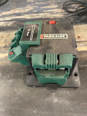 a close up of a green machine on a wooden table